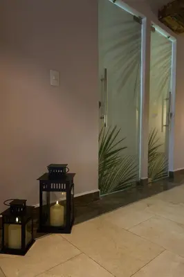 a room with two candles in front of a glass door at Kamaleb Farallones Hotel in Quibdó