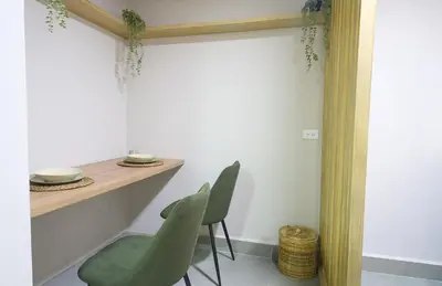 a dining room with green chairs and a table at Kamaleb Farallones Hotel in Quibdó