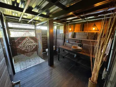 a room with a sauna with a bench and a table at Glamping Montecarlo Lodge Cubo de Madera-Guatapé in Guatapé