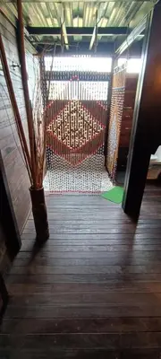 a hammock in a room with a wooden floor at Glamping Montecarlo Lodge Cubo de Madera-Guatapé in Guatapé