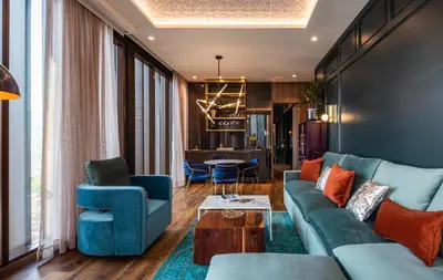 a living room with a couch and chairs and a table at Hotel Marquee Medellín in Medellín