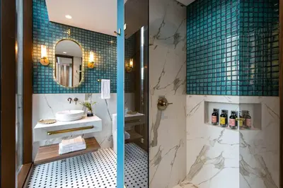 a bathroom with a sink and a mirror at Hotel Marquee Medellín in Medellín
