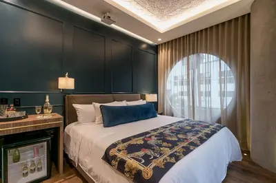 a bedroom with a large bed and a window at Hotel Marquee Medellín in Medellín