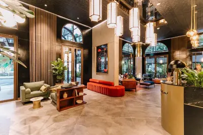 a lobby with chairs and tables in a building at Hotel Marquee Medellín in Medellín