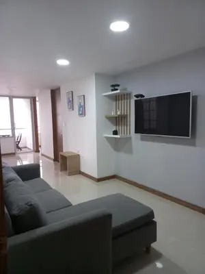 a living room with a couch and a flat screen tv at Apartamento FL Martinz in Manizales
