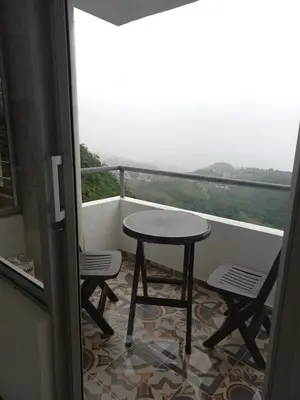 a table and chairs on a balcony with a view at Apartamento FL Martinz in Manizales