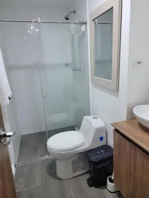 a bathroom with a toilet and a shower and a sink at Apartamento FL Martinz in Manizales