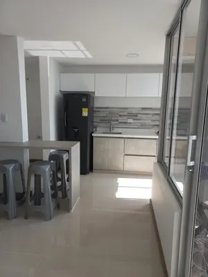 a kitchen with a table and stools in a room at Apartamento FL Martinz in Manizales