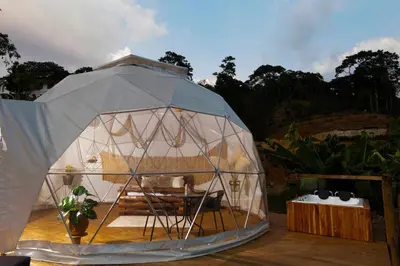 a large iguana tent with a table in it at Entre Verdes Hotel & Glamping in Medellín