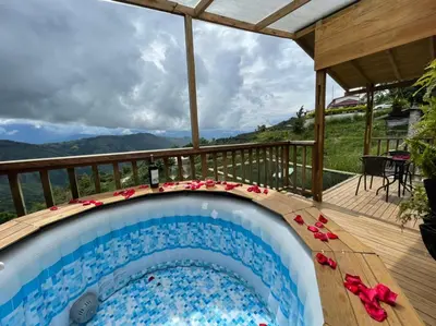 a swimming pool on the deck of a house at Entre Verdes Hotel & Glamping in Medellín