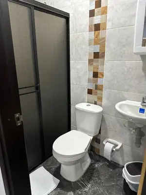 a bathroom with a toilet and a sink at Como en casa in La Dorada