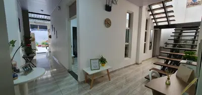 a room with a staircase and a living room at Como en casa in La Dorada