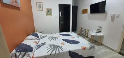 a bedroom with a bed with a comforter on it at Como en casa in La Dorada