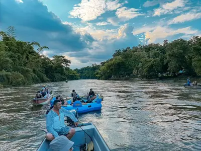 a group of people in boats on a river at Refugio Monte Oscuro in Las Mercedes