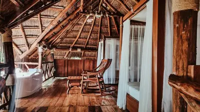 a room with two chairs and a tub in a building at Refugio Monte Oscuro in Las Mercedes