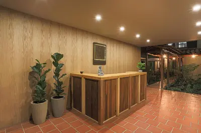 a lobby with a reception desk and potted plants at Soy Local Guatape Campestre in Guatapé