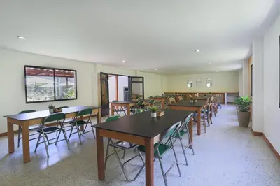 a dining room with tables and chairs at Soy Local Guatape Campestre in Guatapé