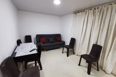 a living room with a couch and a table and chairs at Hermoso y cómodo apartamento in San Rafael