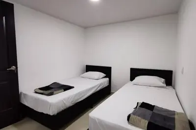 two beds sitting next to each other in a room at Hermoso y cómodo apartamento in San Rafael