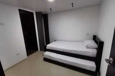 a small bedroom with two beds and a window at Hermoso y cómodo apartamento in San Rafael