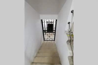a stairway with a gate in a white wall at Hermoso y cómodo apartamento in San Rafael