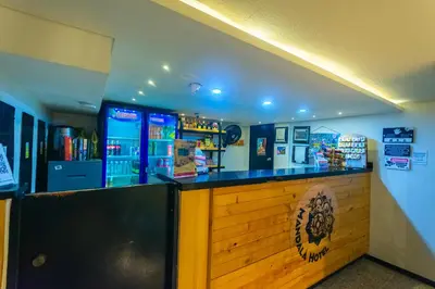 a bar in a restaurant with a counter at Mandala Medellin Botero By GyC Hotels in Medellín