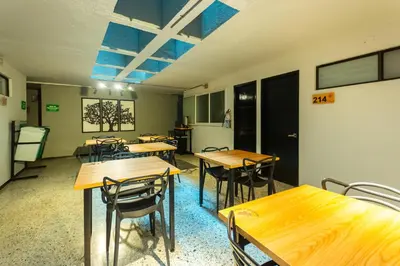 a group of tables and chairs in a room at Mandala Medellin Botero By GyC Hotels in Medellín
