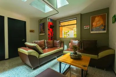 a living room with two couches and a table at Mandala Medellin Botero By GyC Hotels in Medellín