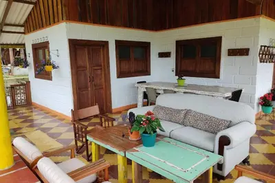 a living room with a couch and a table at Finca La Antigua. finca tradicional Cafetera in Jardin