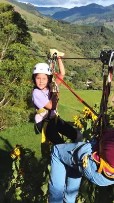 a young girl riding on a zip line at Finca La Antigua. finca tradicional Cafetera in Jardin
