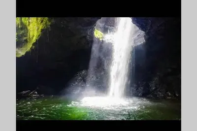 a waterfall in the middle of a pool of water at Finca La Antigua. finca tradicional Cafetera in Jardin