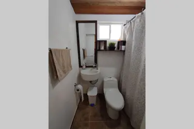 a small bathroom with a sink and a toilet at Finca La Antigua. finca tradicional Cafetera in Jardin