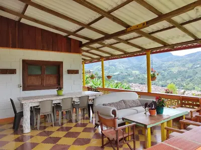 a living room with a table and chairs at Finca La Antigua. finca tradicional Cafetera in Jardin