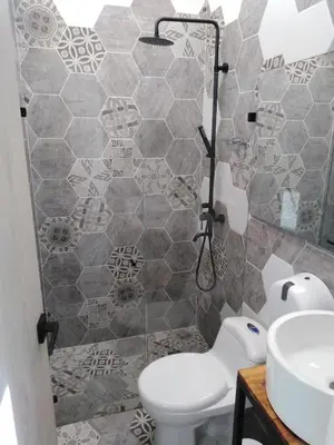 a bathroom with a toilet and a sink at Hotel HACIENDA SAN AGUSTIN in Marinilla