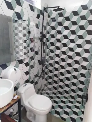 a bathroom with a toilet and a sink at Hotel HACIENDA SAN AGUSTIN in Marinilla