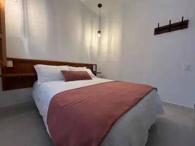 a bedroom with a large bed with a brown blanket at Casa Isabel Hotel in Jardin