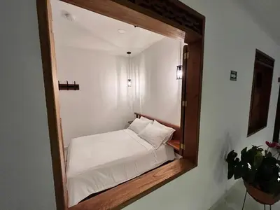 a mirror reflecting a bed in a small room at Casa Isabel Hotel in Jardin