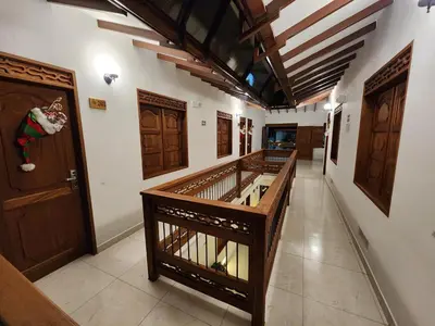 a hallway with wooden doors and a hallway with tiled floors at Casa Isabel Hotel in Jardin