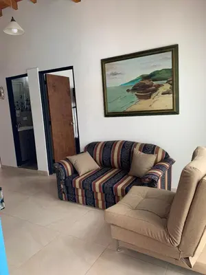 a living room with a couch and a picture on the wall at Apartamento La Esperanza Guatapé in Guatapé