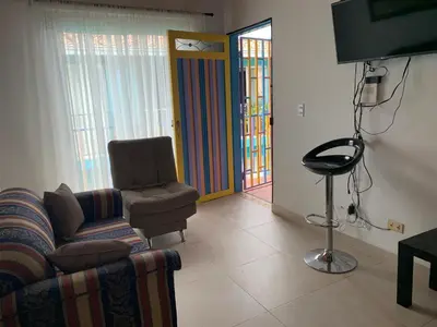 a living room with a couch and a chair at Apartamento La Esperanza Guatapé in Guatapé