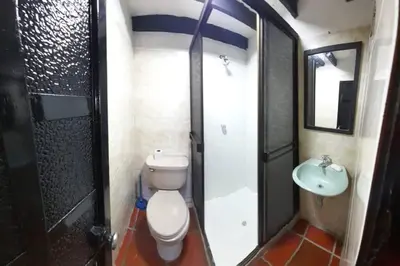 a bathroom with a toilet and a sink at Apartamento campestre in Manizales