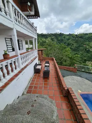 a balcony of a house with a swimming pool at Apartamento campestre in Manizales