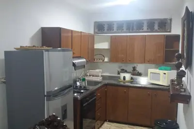 a kitchen with wooden cabinets and a stainless steel refrigerator at YoamoJardin ... es como estar en casa in Jardin