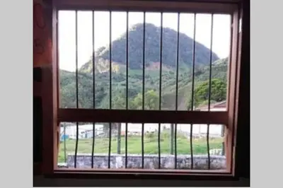 a window with a view of a mountain seen through it at YoamoJardin ... es como estar en casa in Jardin