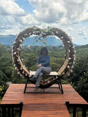a woman sitting in a heart shaped wreath at Eco-Glamping Shalom in Mariquita
