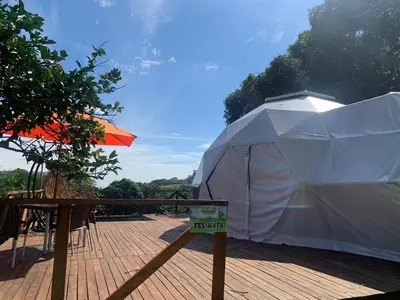 a large white tent on a deck with a sign at Eco-Glamping Shalom in Mariquita