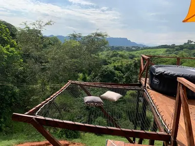 a bird cage sitting on top of a deck at Eco-Glamping Shalom in Mariquita
