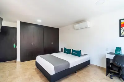 a bedroom with a bed and a desk and a chair at Ayenda Coliving la 78A in Medellín