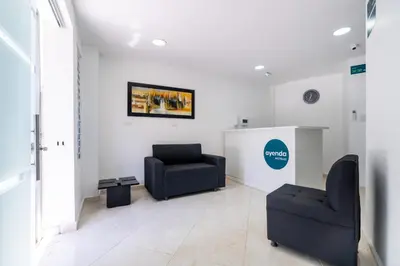 a waiting room with two chairs and a couch at Ayenda Coliving la 78A in Medellín