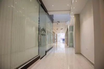 a hallway in a building with a glass wall at Hotel Silver Guarne in Guarne